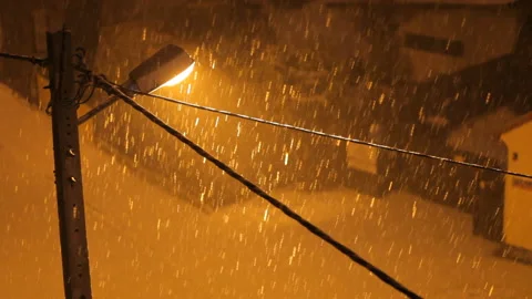 Background. Night heavy snowfall in the light of a street lamp. Snow hypnosis. Video stock 101558474