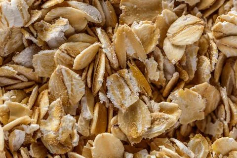 Background of oatmeal. Daylight. Throughout the frame are oatmeal flakes.Diet Stock Photos