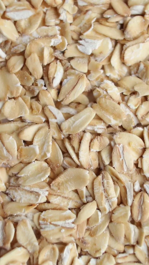 Background of oats grains rotating close up, top view. Vertical video. Stock Footage 269310792