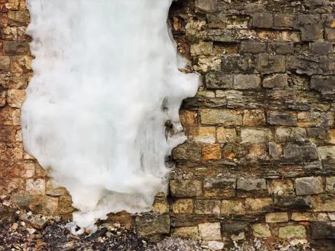 Background old brick wall with big icicle, texture. Vintage Stock-Fotos