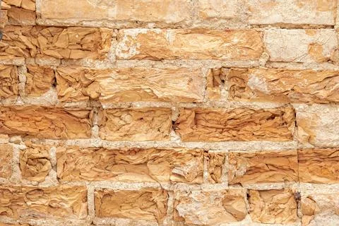 Background from an old brick wall with bricks crumbling from age Foto stock