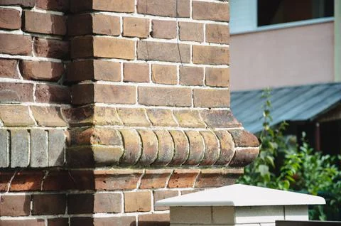 The background is an old brick wall is made of red ceramic bricks. Stock Photos
