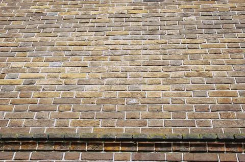 The background is an old brick wall is made of red ceramic bricks. Stock Photos