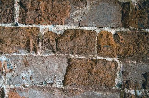 The background is an old brick wall is made of red ceramic bricks. Stock Photos