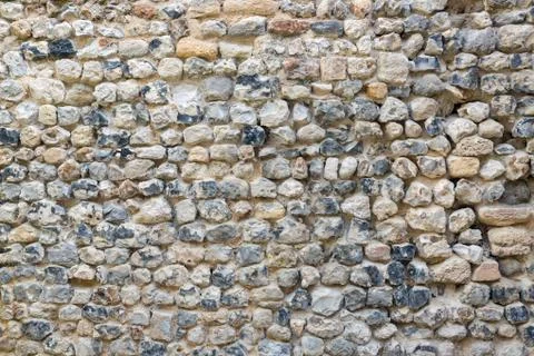 Background old brickwork with stones of different color Stock Photos