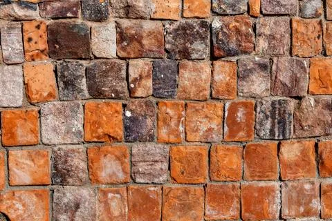 Background old broken brown-yellow brick wall Stock Photos