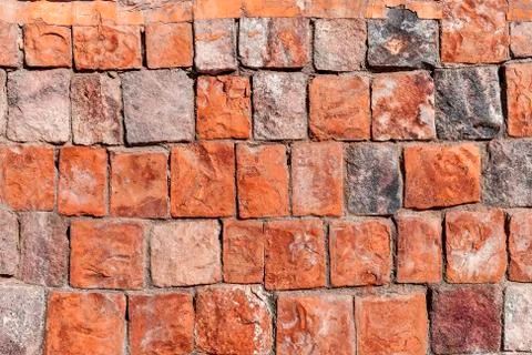 Background old broken brown-yellow brick wall Stock Photos