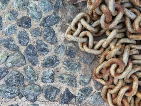Background with old chain boat on the rocks Stock Photos