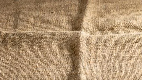 Background of old coarse burlap close-up illuminated by side light Stock Photos