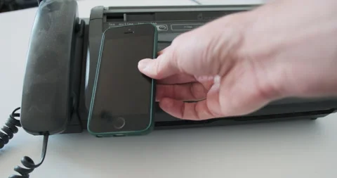 Background of an old fax, hand demonstrates modern mobile phone. Concept of Vídeo Stock 289632582