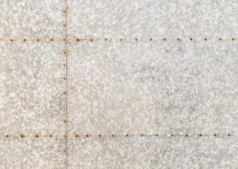 Background of an old metal sheet with rusty rivets. Stock Photos