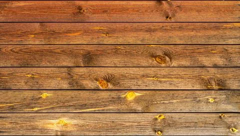 Background of old pine boards with knots. Brown with yellow. Stock Photos