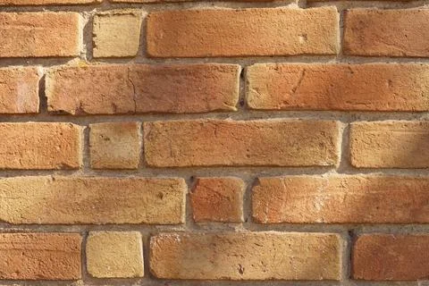 Background old red brick wall in sunny day. Stock Photos
