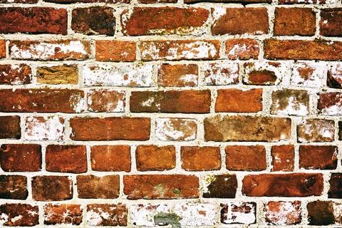 Background of an old red brick wall. Vintage film camera effect added Stock Photos