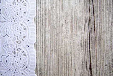 The background is from old rough ragged damaged gray boards and a white lace  Stock Photos