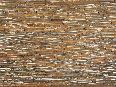 Background of old rusty drill bits of various sizes. Stock Photos