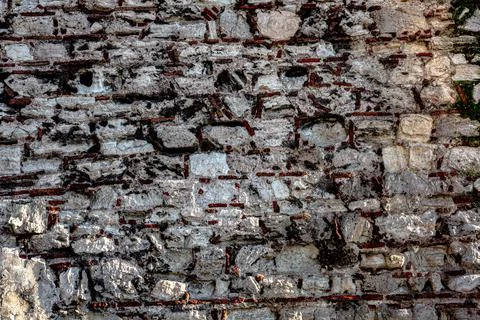 Background. Old stone wall with brick Stock Photos
