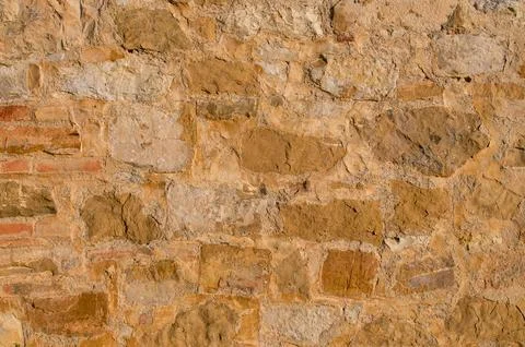 Background of an old stone wall with irregular rocks and mortar Foto stock