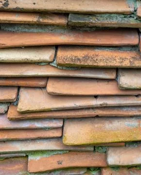 Background from the old tiled masonry. Orange tiles. Wall made of clay frag.. Stock Photos