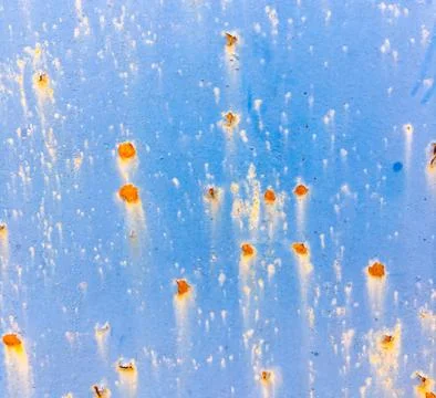 Background of an old wall covered in blue paint. Rusty metal surface. Stock Photos