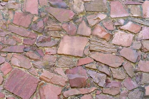 Background of an old wall made of red stone. Fotos de archivo