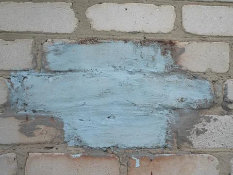 Background of an old wall of white blocks with a blue-colored place for your  Foto stock