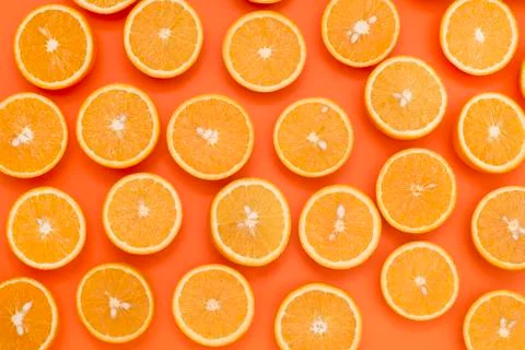 Background from the oranges cut in half on an orange background Stock Photos