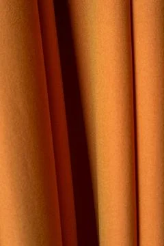 Background of pale red fabric with vertical folds Stock Photos