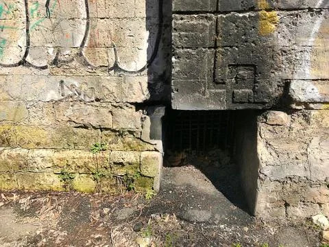 The background is part of an old brick wall with a niche. Stock Photos