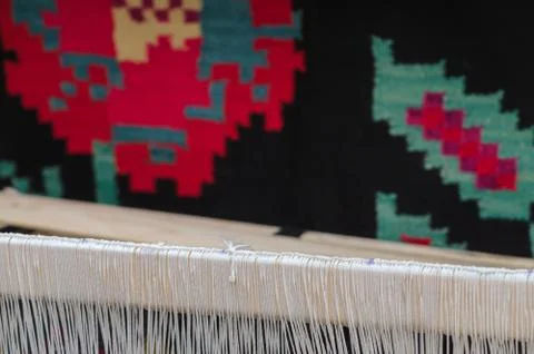Background part of the rug made of wool and the warp threads on the loom Stock Photos