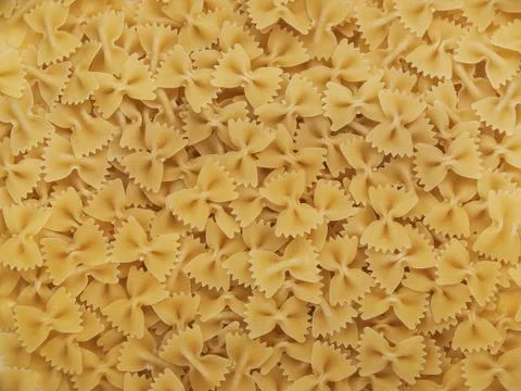 Background of pasta in the form of bows Stock Photos