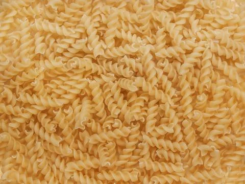 Background of pasta in form of spirals Stock Photos