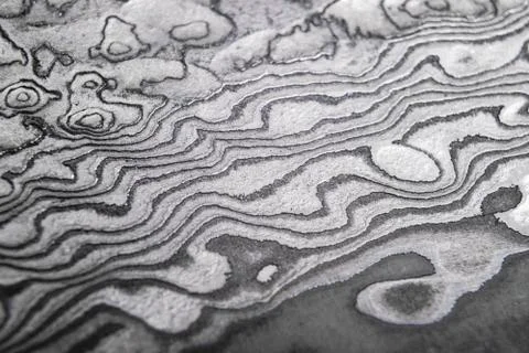 Background with pattern of damask steel. Close up. Macro shot of a damascus k Stock Photos