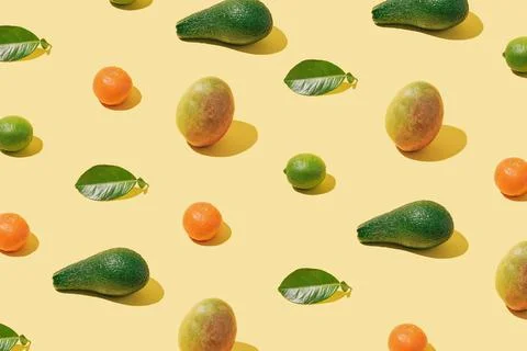 Background pattern with fresh fruit and green leaf layout  yellow substrate Stock Photos