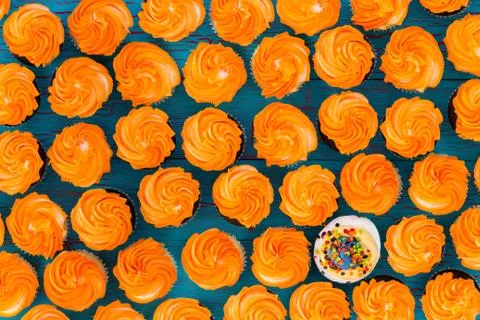 Background pattern of glazed orange cupcakes Stock Photos