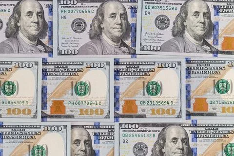 Background pattern of hundred US dollar bills with Benjamin Franklin portrait Stock Photos