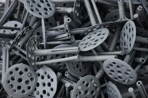 Background pattern of many gray plastic dowels (fastening) for thermal insula Stock Photos