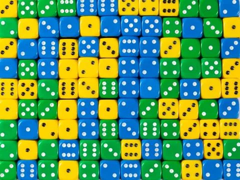 Background pattern of random ordered yellow, green and blue dices Stock Photos