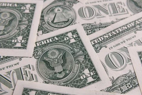 Background Pattern of Scattered One US Dollar Bills Showing Reverse Side Sy.. Stock Photos