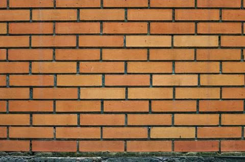 Background pattern of slightly weathered colorful orange brick wall Stock Photos