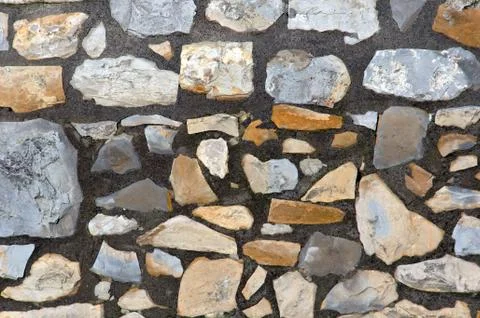 Background of a pattern with textured stone blocks on a wall Stock Photos