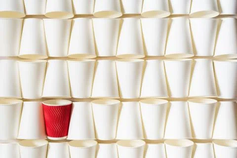 Background pattern of white paper cups with red cup in the middle Stock Photos