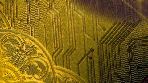 Background of a patterned embossed golden colored is glitters in a beam of light Stock Footage 151993753