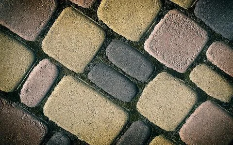 Background of Patterned surface of different colors made of concrete. Stock Photos