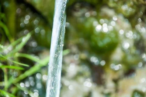 Background of pebbles seen through rippling water Stock Photos