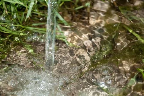 Background of pebbles seen through rippling water Stock Photos