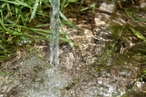 Background of pebbles seen through rippling water Stock Photos