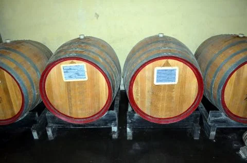 Background perspective inside a winecellar full of wooden barrels Stock Photos
