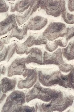 Background picture wave pattern in the sand at the beach of the Baltic Sea near Stock Photos