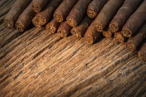 Background, pile of small cigar on old wooden table 写真素材